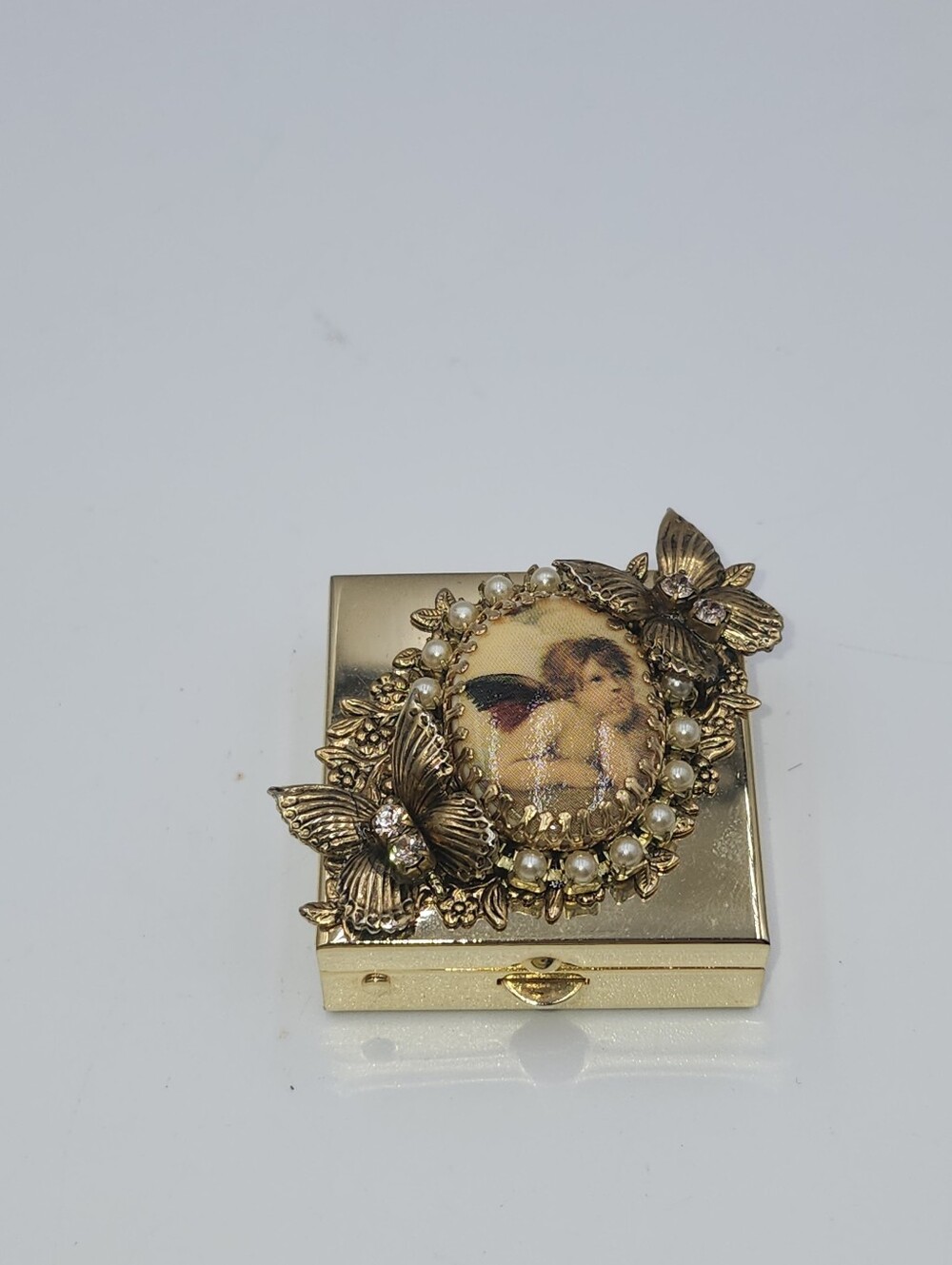 Vintage gold tone small angel cherub jeweled brass Pill Box butterfly